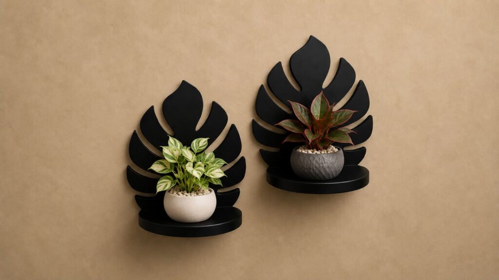 Minimalist leaf-shaped floating plant shelf with textured grey stone pot on sand-colored wall
