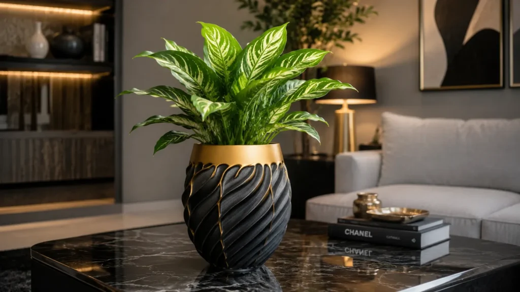 Carved black luxury indoor plant pot with golden accents on a marble coffee table