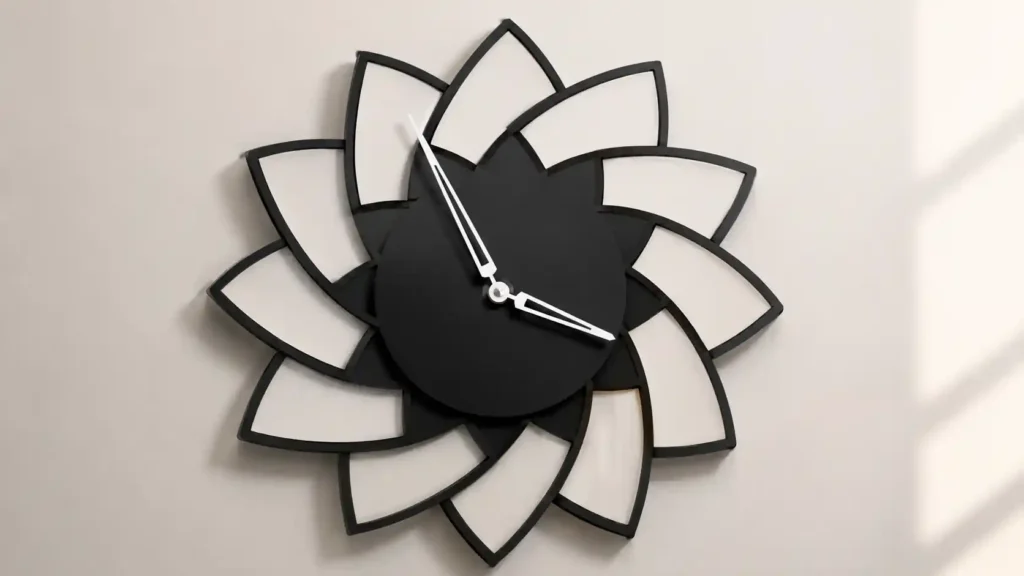 Geometric flower pinwheel wall clock with overlapping black and white curved petal panels, a central black dial, and silver hands.